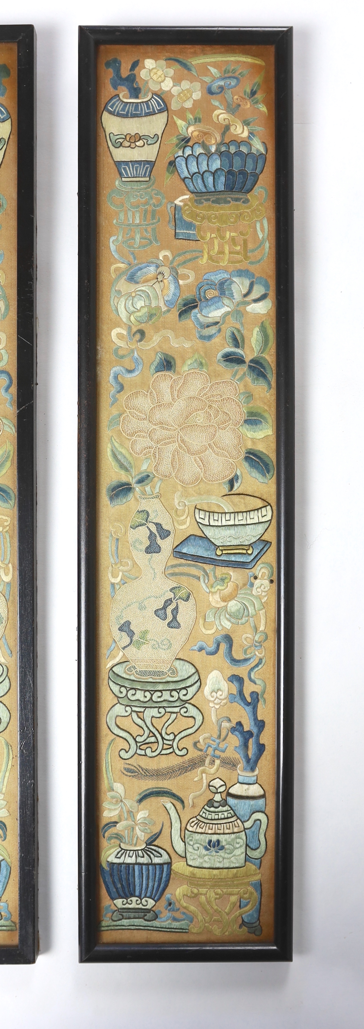 A pair of late 19th century / early 20th century Chinese silk embroidered sleeve bands, embroidered mostly with Chinese knot and stem stitch with unusual auspicious symbols each, 9.5cm wide x 49.5cm high (framed separate